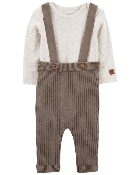 A baby outfit with a cream top and brown sweater coveralls