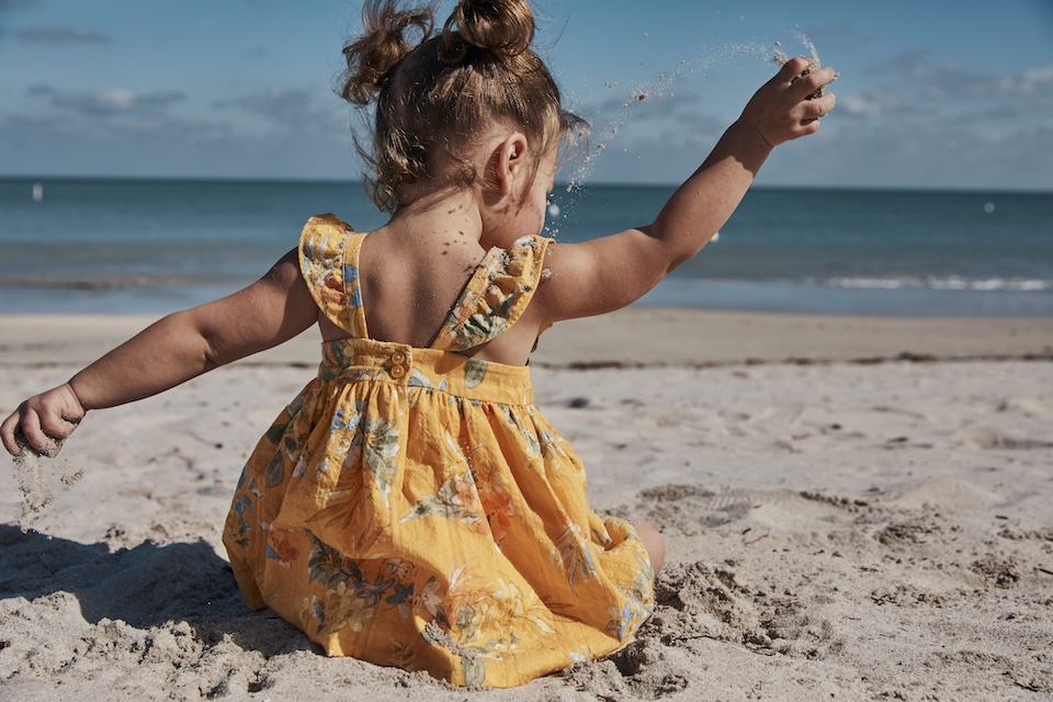 baby playing in sand